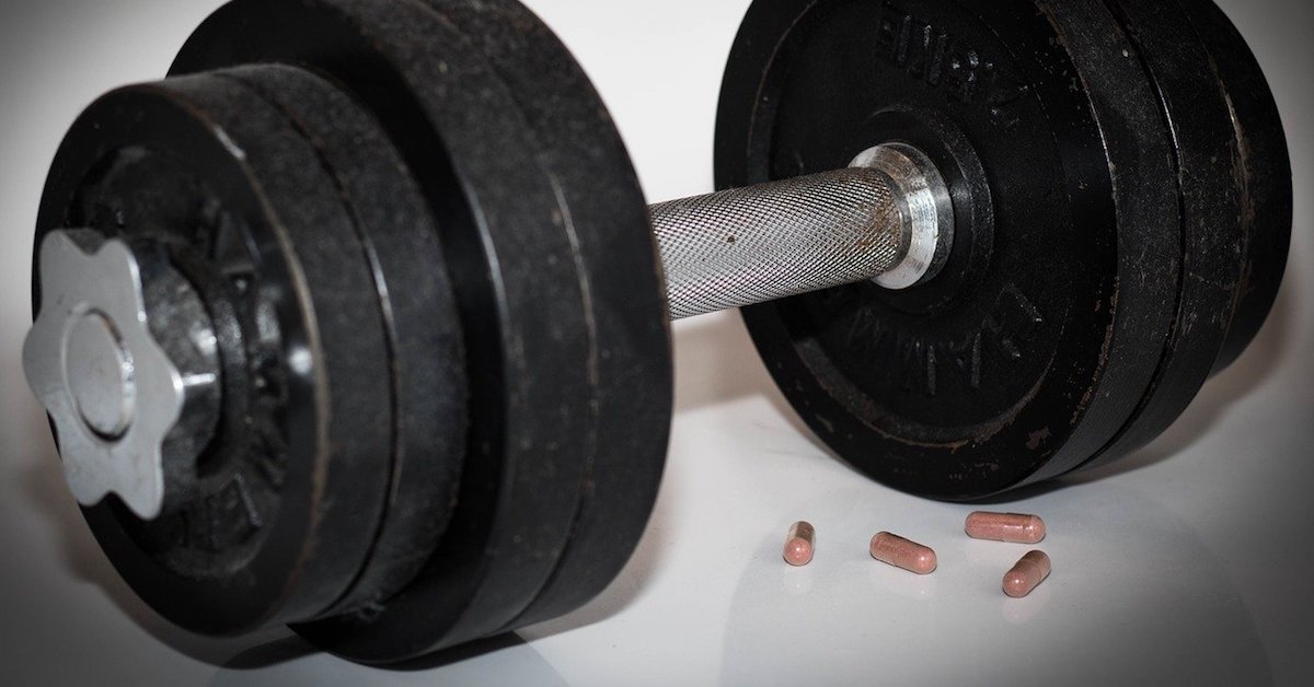 dumbbell and pills