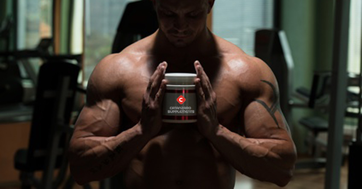 Bodybuilder Posing With Catanzaro Supplements Bottle